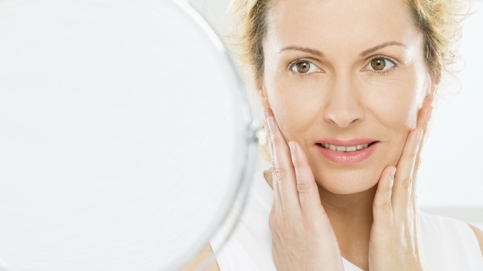 Woman fretting at mirror