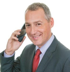 Mature Male Businessman smiling on phone (portrait)