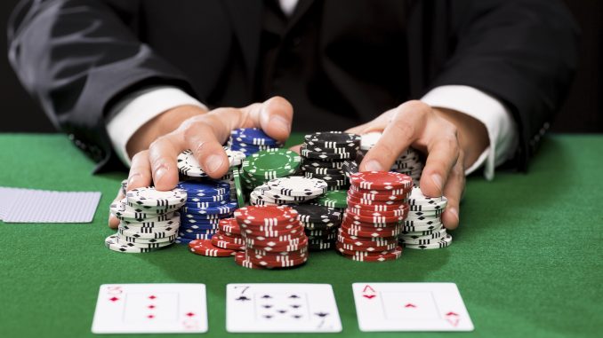 poker player with cards and chips at casino plastic surgery overseas,