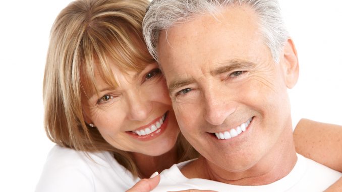 Elderly smiling couple on white background
